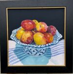 Plums on blue and white bowl