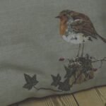 Winter robin embroidered linen cushion